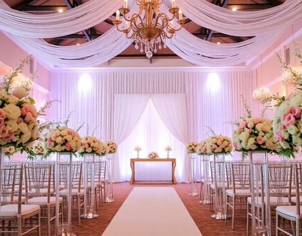 Elegant wedding venue with floral arrangements and soft lighting.